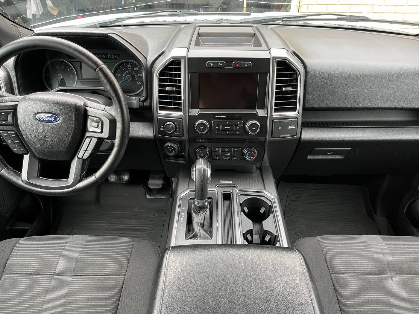 Clean Ford truck interior, showing dashboard, steering wheel, and console. Perfect for a comfortable rv rental adventure. — photo 13