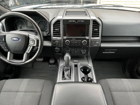 Clean Ford truck interior, showing dashboard, steering wheel, and console. Perfect for a comfortable rv rental adventure.
