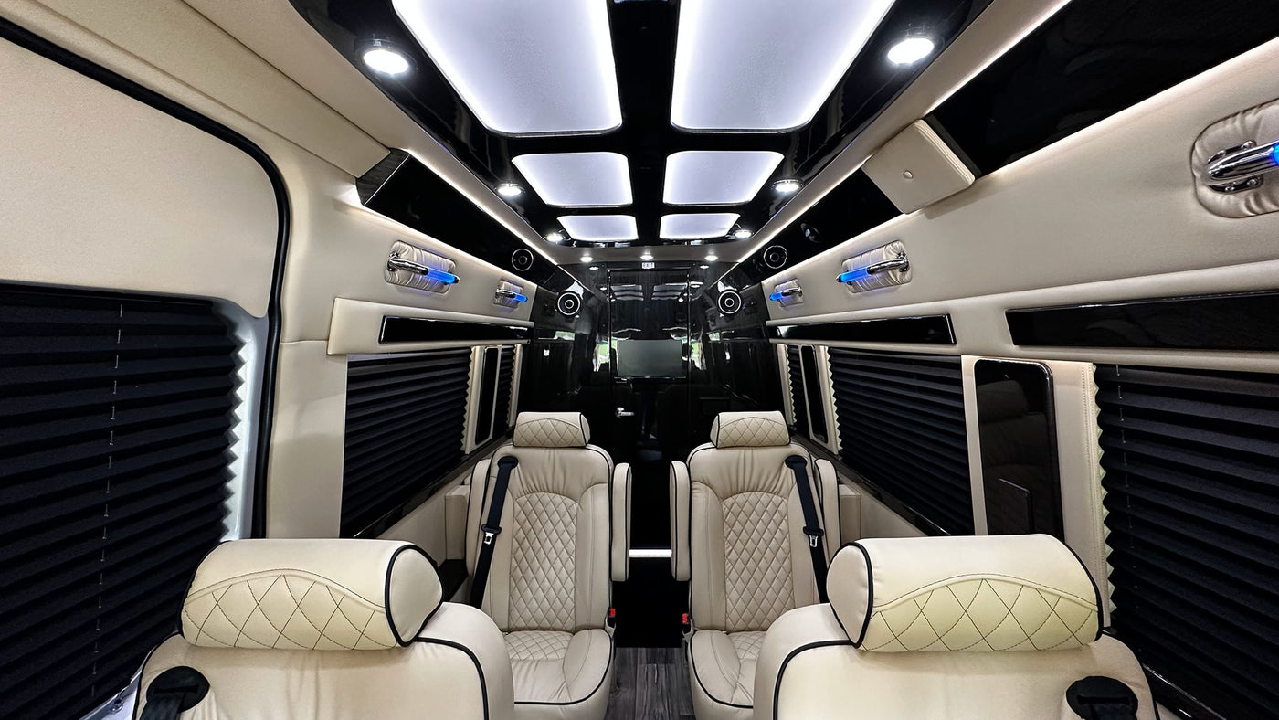 Inside a spacious RV rental, cream quilted leather seats, black window shades, and bright ceiling lights create a luxury travel experience. — photo 12