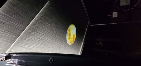 RV rental outdoor cinema: A planet projected onto a large RV awning at night. Great for camping movie nights!
