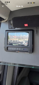 Inside an RV rental: BMPRO control panel and display screen show an outdoor scene, with a JBL speaker above for entertainment.