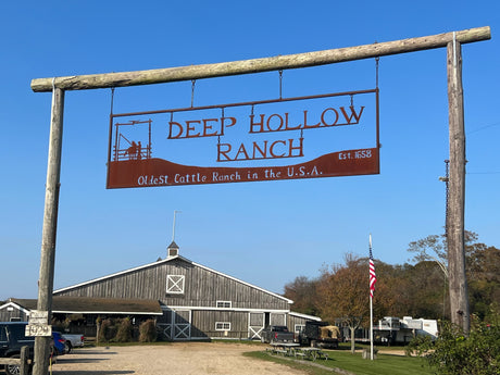 Deep Hollow Ranch, oldest cattle ranch (est. 1658) in the USA. A barn, flag, and an RV rental are visible.