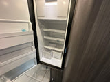 This empty rv rental refrigerator awaits your groceries. Featuring interior shelves, door storage, and crisper bins.