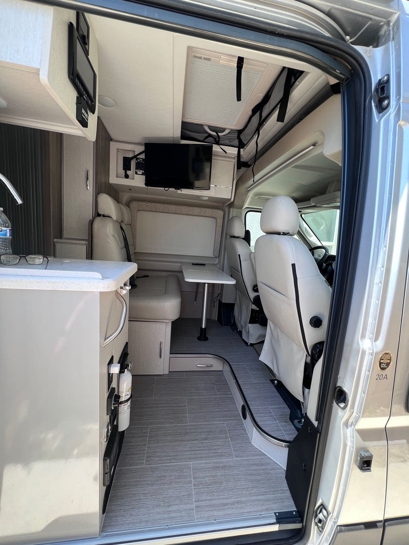  parked in a driveway.|Inside this RV rental: a bright — photo 3