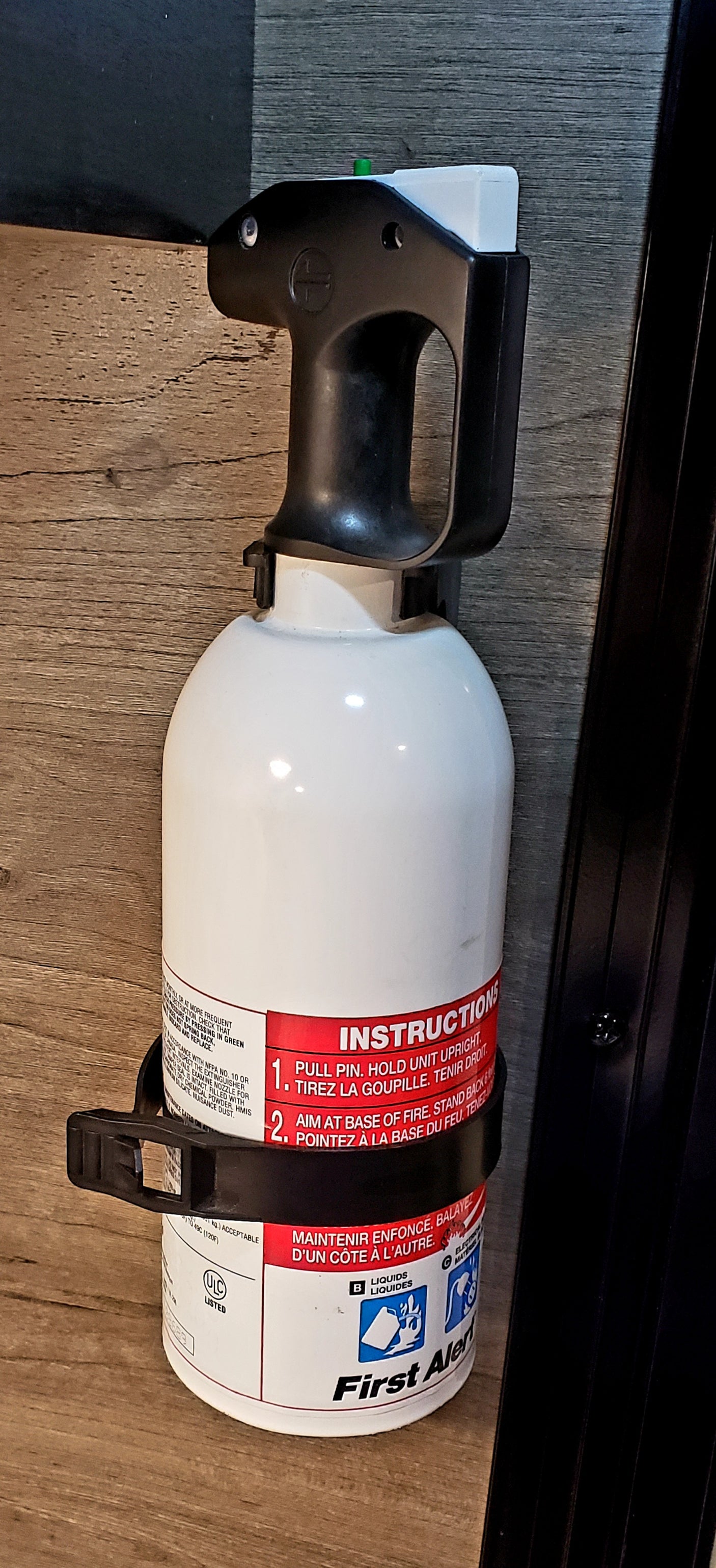 White First Alert portable fire extinguisher with instructions, key for RV rental safety.