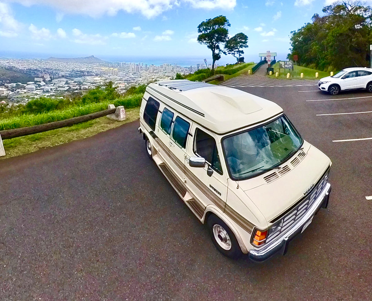 Cream camper van RV rental parked at a scenic Hawaii overlook, offering panoramic city and ocean views. — photo 14