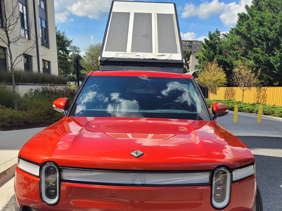  perfect for an rv rental or electric outdoor adventure.|A bright red Rivian R1T electric truck with an overland camper shell — photo 15
