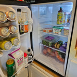 Well-stocked RV rental mini-fridge featuring sparkling water, oat milk, plant butter, and other fresh provisions.
