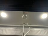 RV rental ceiling: Illuminated lights, a smoke detector, and important safety warnings for occupants.