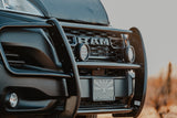 Front view: rugged black Ram truck with brush guard, auxiliary lights, and Arizona flag. Your RV rental adventure begins!