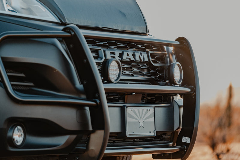 Front view: rugged black Ram truck with brush guard, auxiliary lights, and Arizona flag. Your RV rental adventure begins! — photo 17