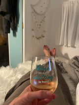Cozy RV rental evening. Relaxing with feet up, holding a wine glass that reads "adulting is hard."