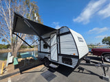  and a pot in a cabinet with an outlet.|RV rental kitchen featuring a sink