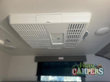 Stay cool in your RV rental with this ceiling-mounted air conditioner. Essential for comfortable road trips.