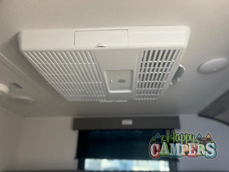 Stay cool in your RV rental with this ceiling-mounted air conditioner. Essential for comfortable road trips.