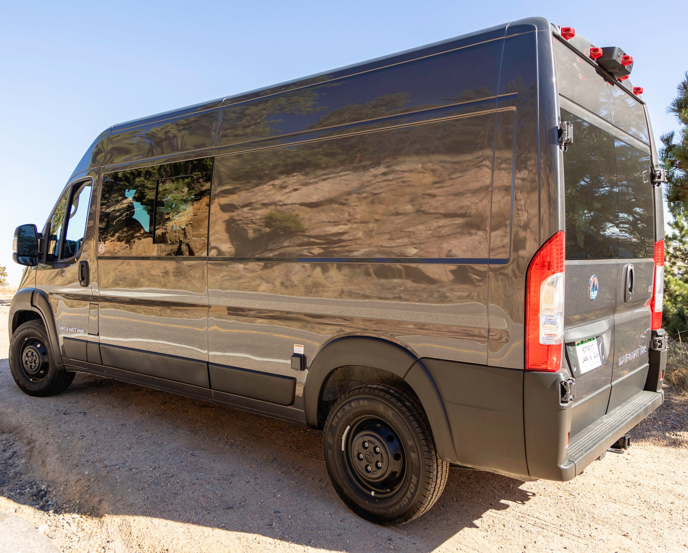 Dark grey Ram ProMaster rv rental van for outdoor adventures, parked on a dirt road. — photo 6