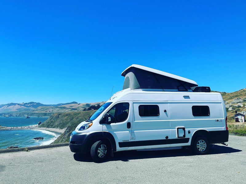 Your next RV rental awaits! Enjoy coastal views from this white pop-top camper van — photo 1