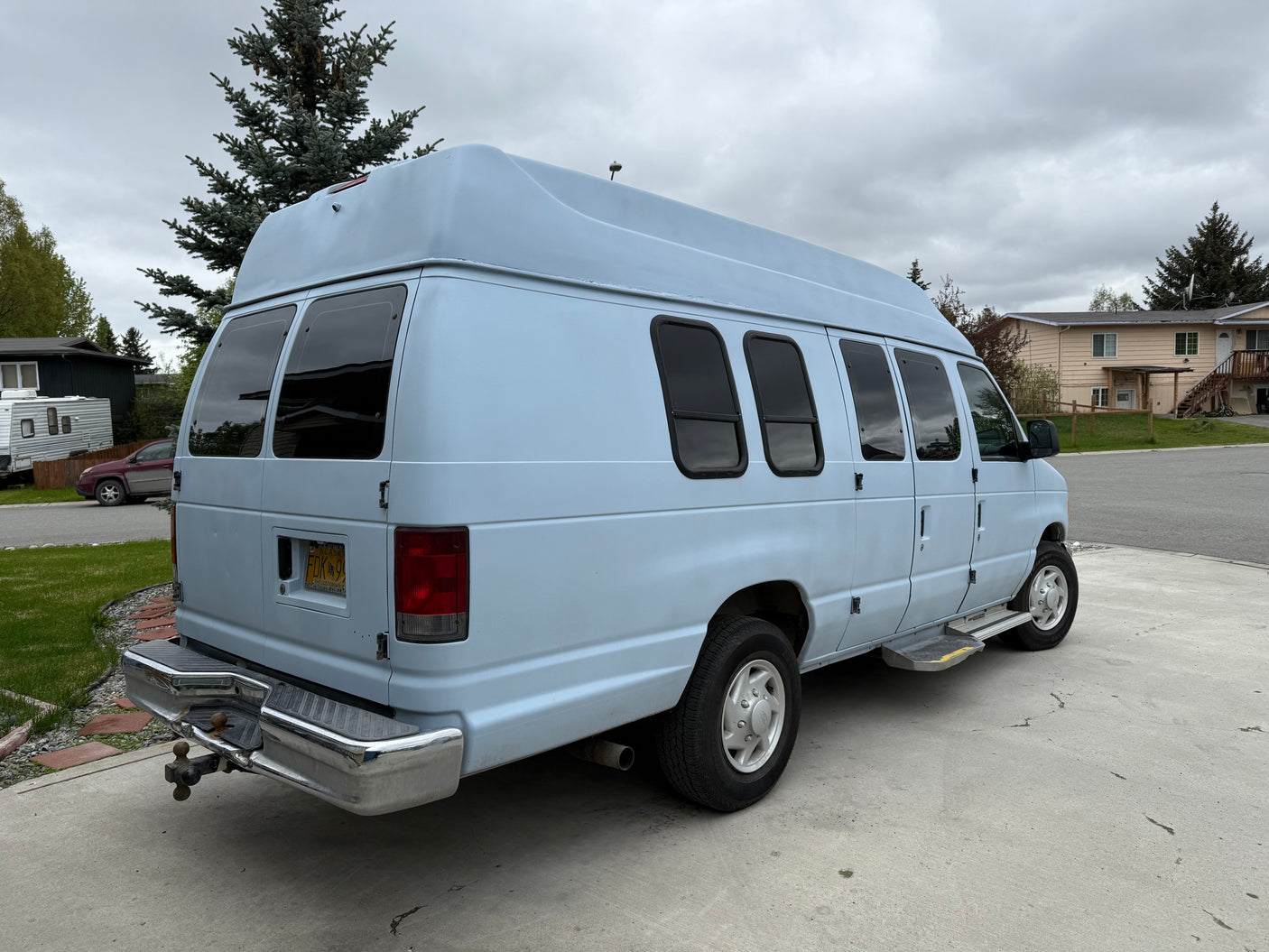 Light blue high-top Ford van, perfect for rv rental adventures. This versatile camper is ideal for exploring Alaska.
