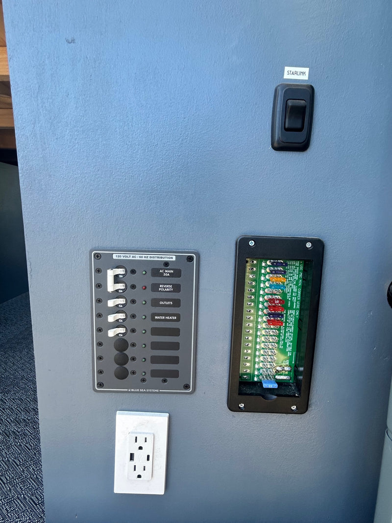  and glass cooktop. Integrated colander & power outlet visible.|This RV rental's cozy interior features a full bed — photo 11