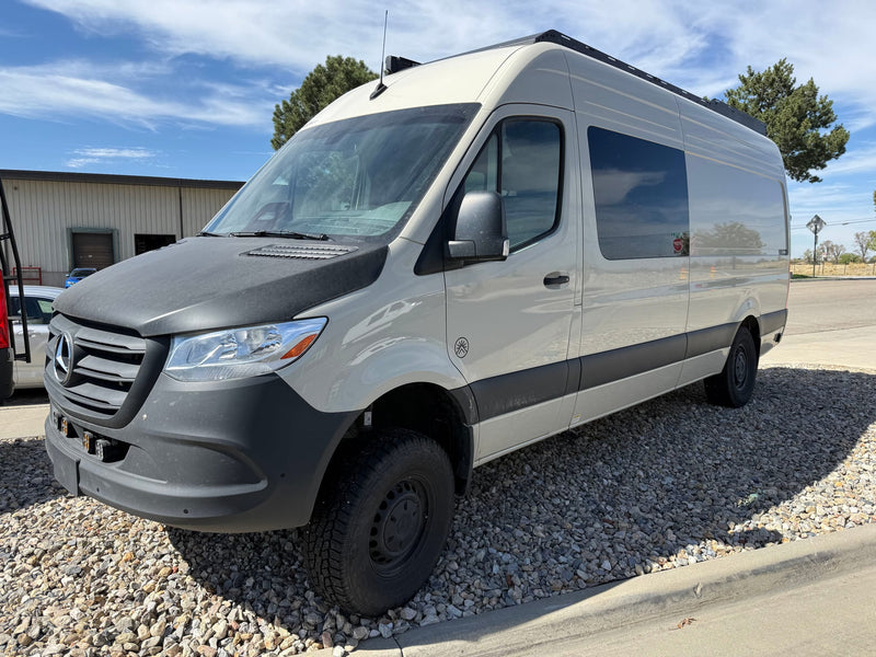 Light-colored Mercedes Sprinter adventure camper van — photo 1