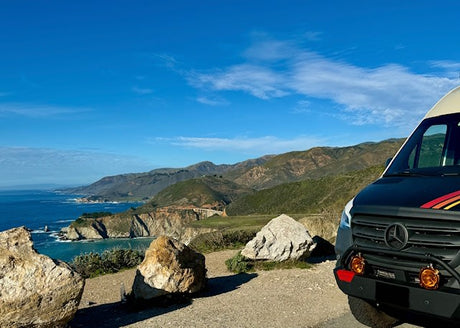 Experience epic Big Sur views! This Mercedes RV rental overlooks the Pacific Ocean, Bixby Bridge, and coastal mountains.