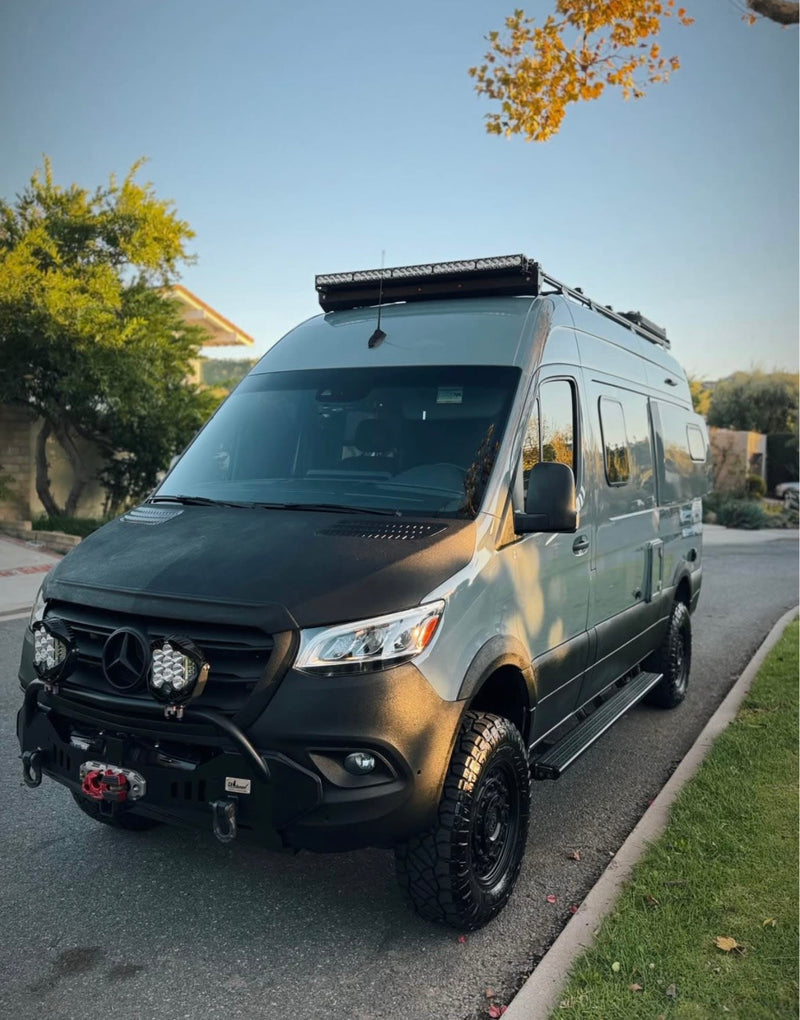 Adventure-ready Mercedes Sprinter camper van with off-road tires and roof lights. Perfect for your next RV rental trip! — photo 6