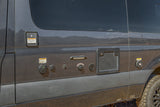 Dark grey RV rental camper van side panel with visible utility connections for fresh water, shore power, city fill, and air intake.