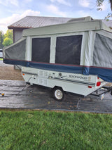 A Rockwood Premier pop-up camper, fully set up for RV rental. Perfect for your camping adventure and outdoor fun.