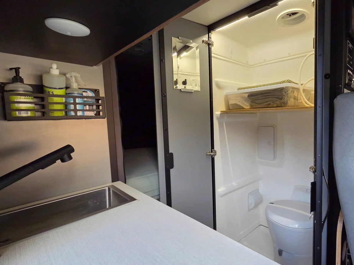  parked by a scenic lake.|Tour this rv rental's interior: a tidy kitchen with sink — photo 8