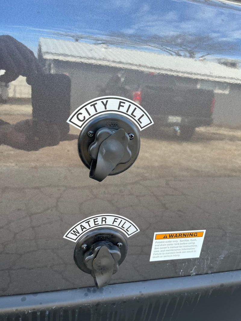 Two water fill ports labeled "CITY FILL" and "WATER FILL" are visible on the side of an RV rental, alongside a safety warning label. — photo 6