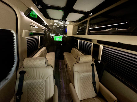 Spacious luxury RV rental interior: cream quilted seats, ambient lighting, and dark wood-style flooring for comfort.