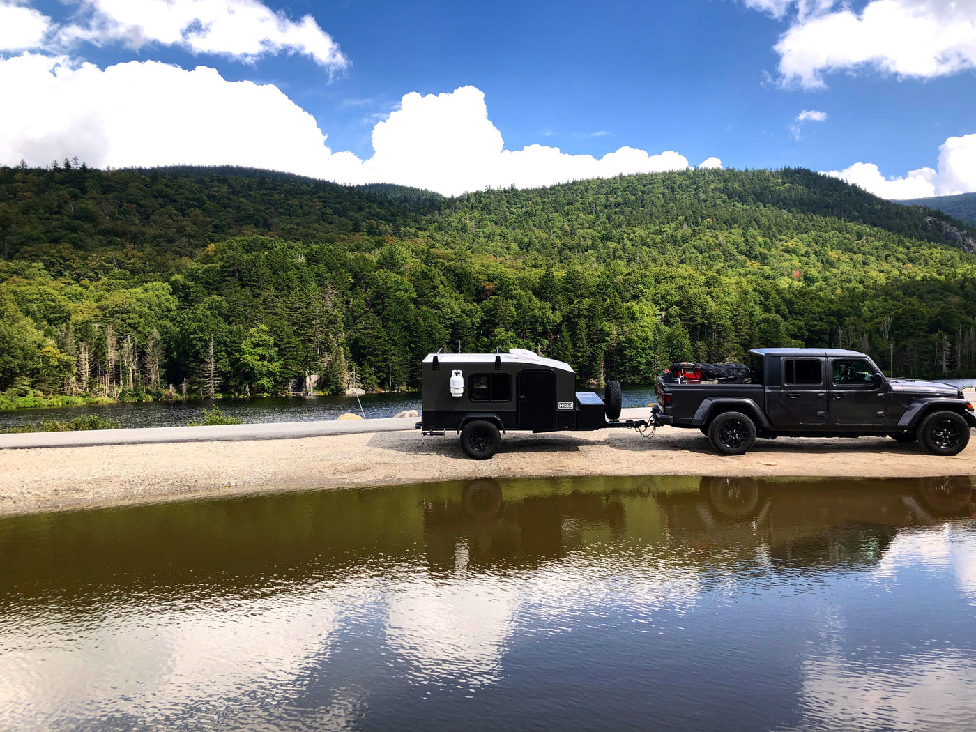 Dark Jeep Gladiator & rugged overland trailer by a lake. Great RV rental for mountain adventures! — photo 2