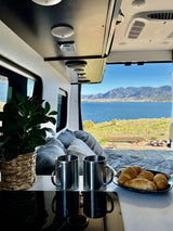 Scenic RV rental: Enjoy lakeside mountain views from your camper van. Coffee & croissants for a perfect morning.