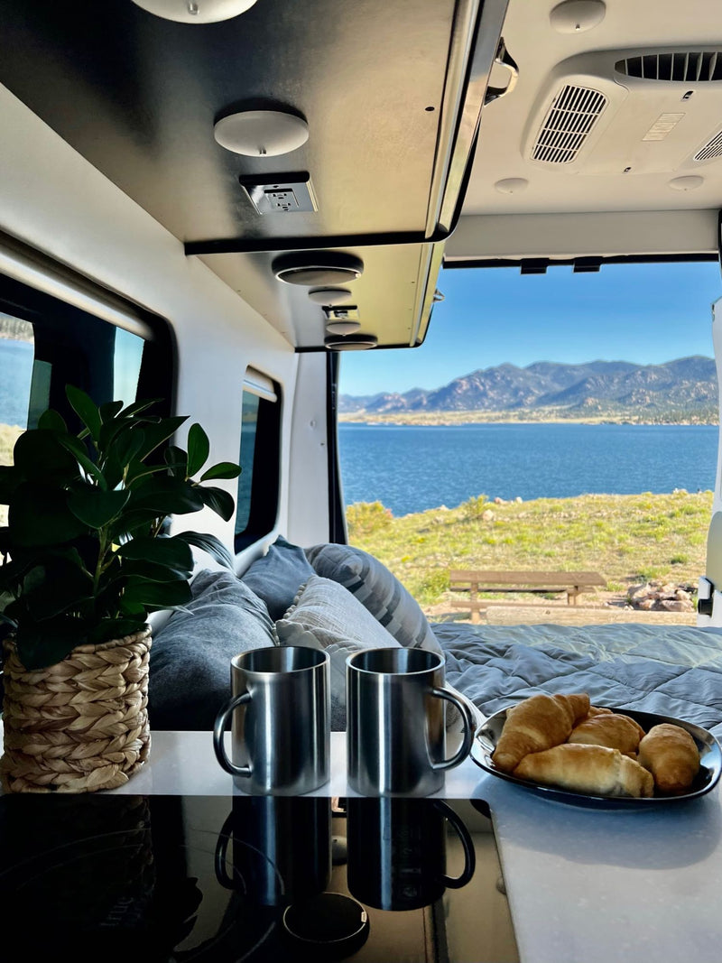 and comfortable bench seating.|This cozy RV rental interior features a comfortable bed — photo 16