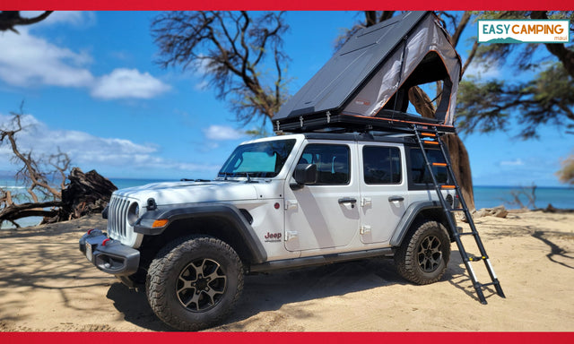 Explore Maui! This RV rental features a white Jeep Wrangler & rooftop tent on a sunny beach, perfect for your next camping adventure.