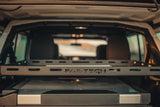 Organized RV rental interior: Fabtech cargo rack above a cooler, ready for adventure.