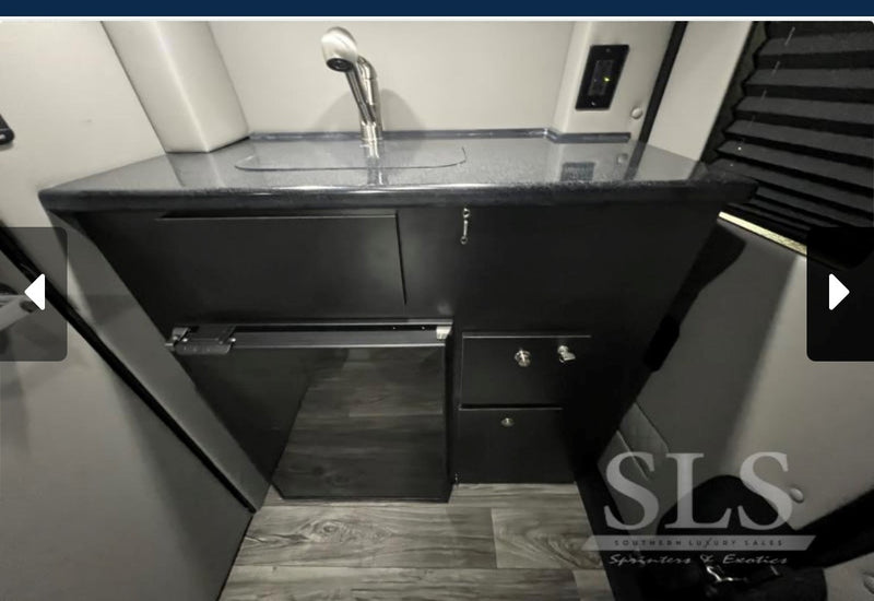  and a mounted screen for travel comfort.|Luxury van RV rental interior: plush quilted beds/seats — photo 6