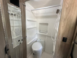 Inside an RV rental, this clean and compact bathroom includes a shower, toilet, and built-in storage for efficient use of space.