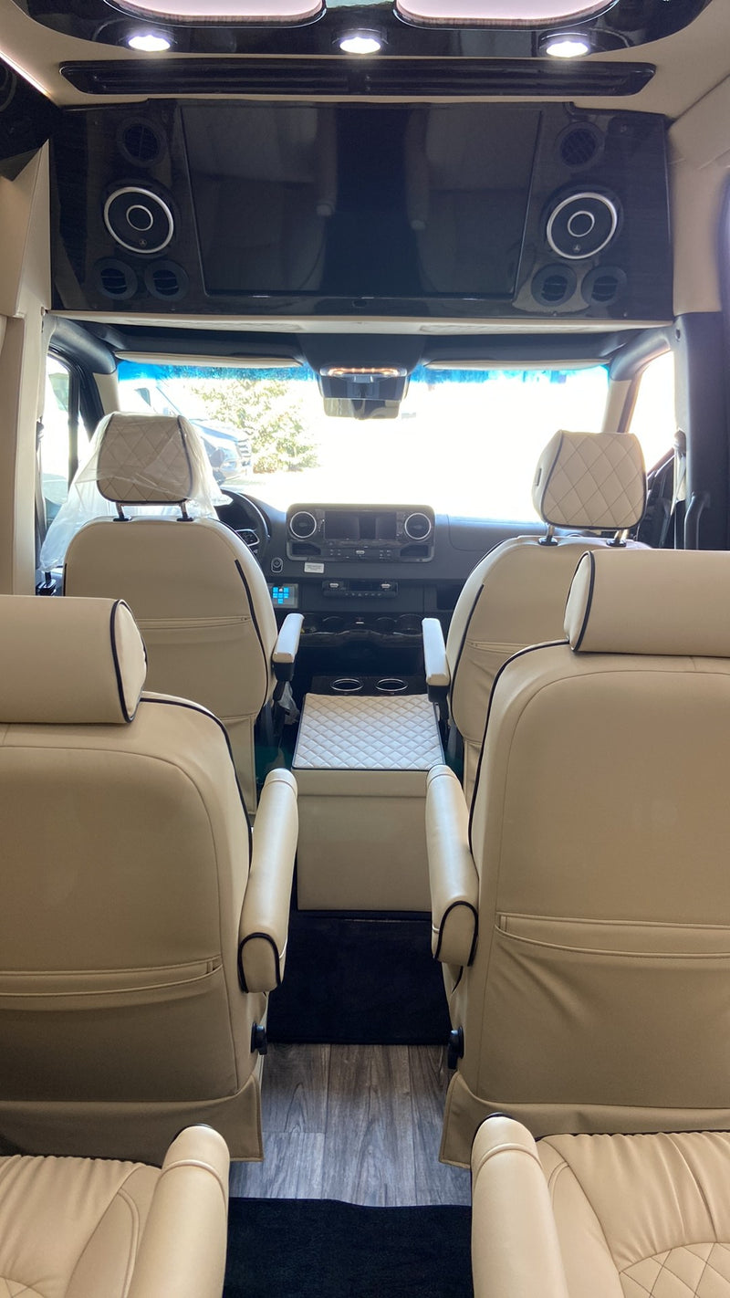 parked by a modern building on a sunny day.|This sleek black Mercedes Sprinter — photo 3