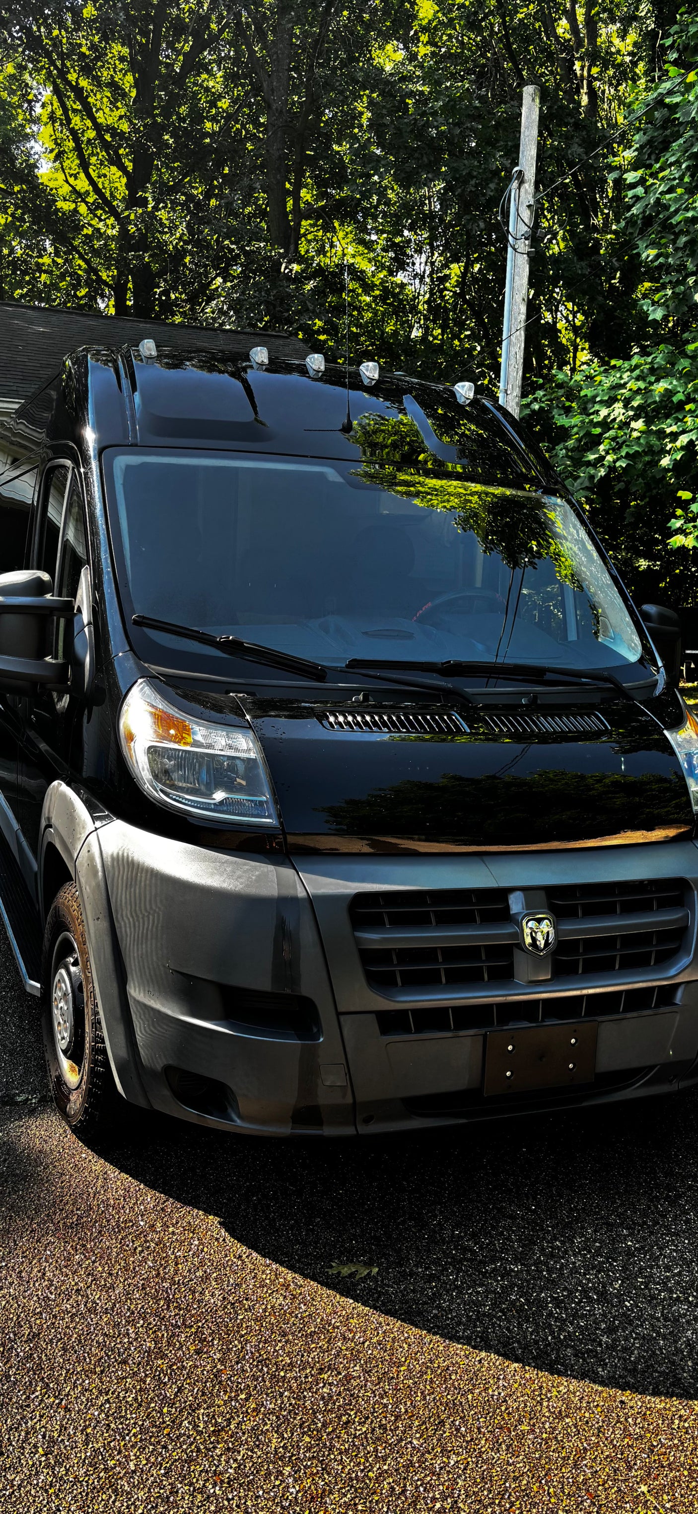 Black ProMaster van, great for RV rental. Front view of this spacious vehicle parked outdoors.