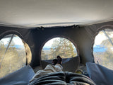 Relaxing with a peaceful nature view from inside a comfortable RV rental. Perfect for glamping adventures!