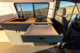 Explore this RV rental's sleek kitchen: sink, cooktop, and pull-out storage drawer. Ideal for mobile adventures.