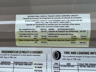RV rental safety: Vehicle's cargo capacity and tire info labels are displayed, crucial for safe loading and driving.