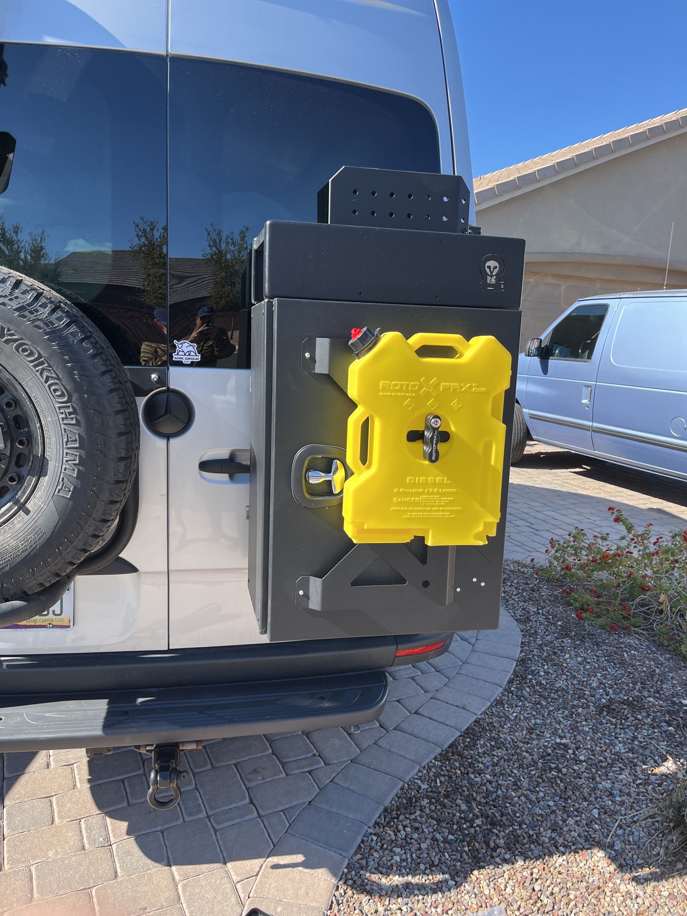 Rear of RV rental van featuring a storage box and yellow RotopaX diesel tank. Perfect for extended adventures.