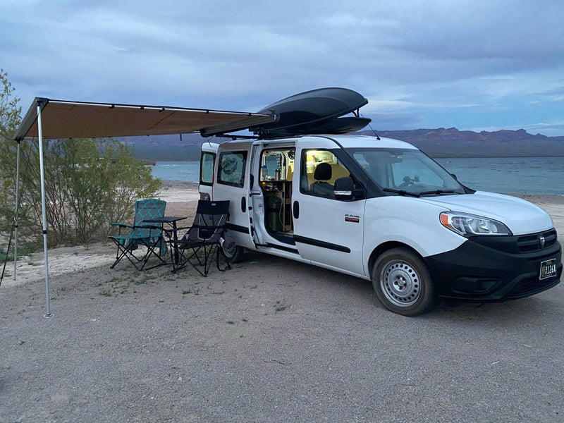  a white camper van with an awning — photo 13