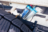Blue King Off-Road Racing Shocks and heavy-duty tire seen from below an RV rental. Enhanced suspension for any adventure.