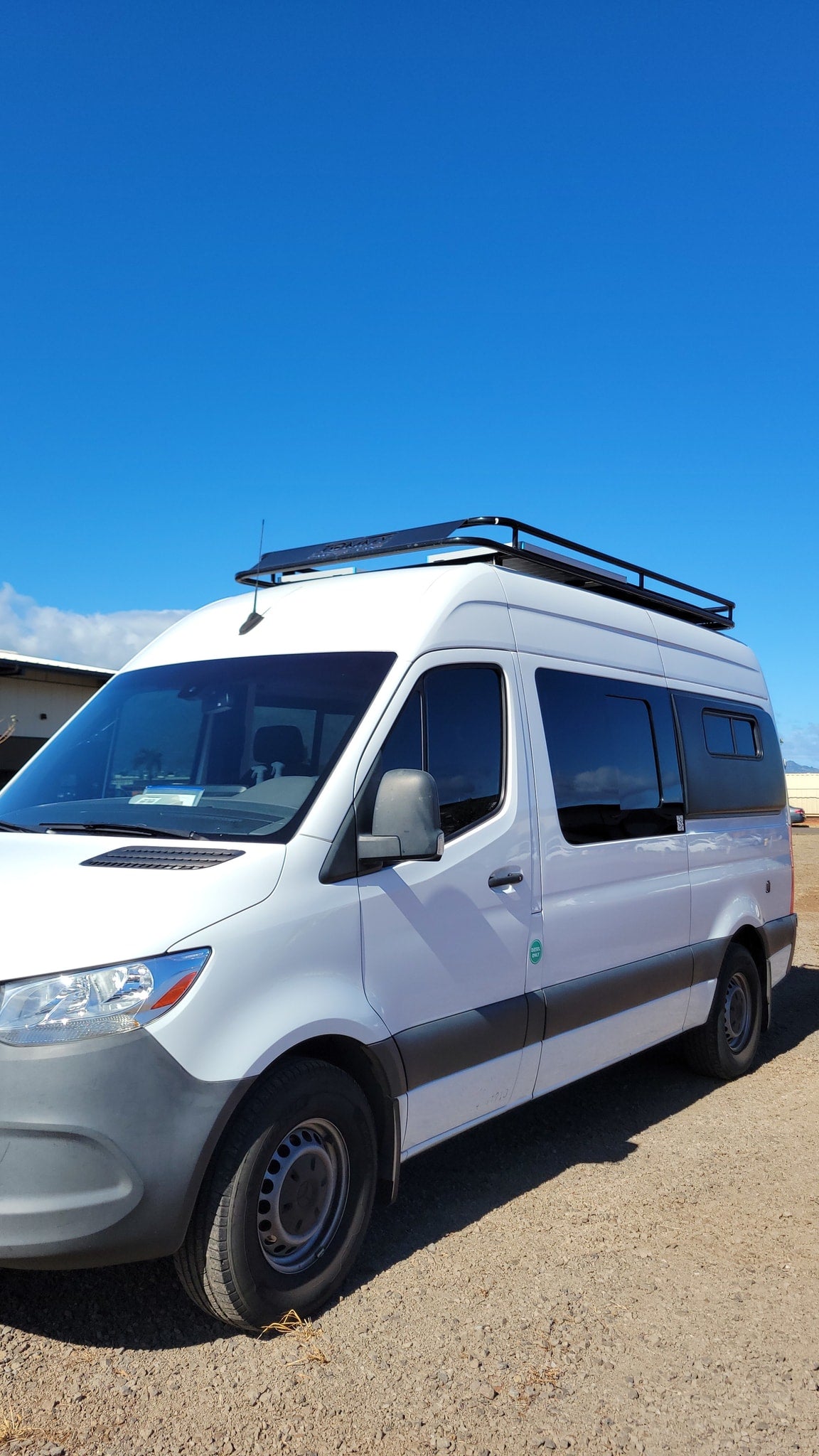  parked in the desert mountains with its custom interior.|Inside this RV rental: a custom wood kitchen with sink — photo 13