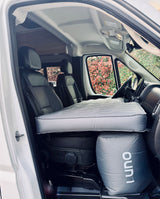 Cozy RV rental setup: Luno inflatable mattress spans the front seats, creating a convenient sleeping area in this camper van.