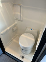 This RV rental features a clean, compact wet bath with a toilet and shower for your journey.