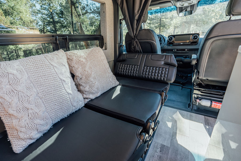  and forest views through windows.|Modern RV rental interior with front swivel seats — photo 12